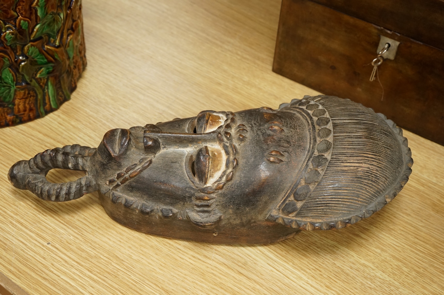 A carved African Guro mask from the Ivory Coast, 40cm long.